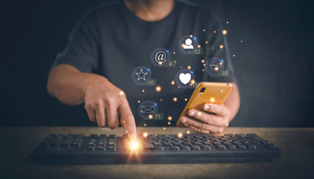 istock Man hand using social media marketing on smartphone and computer keyboard with notification icons of message, e-mail, comment and star on mobile phone, Social media interactions on internet concept. 2159993819