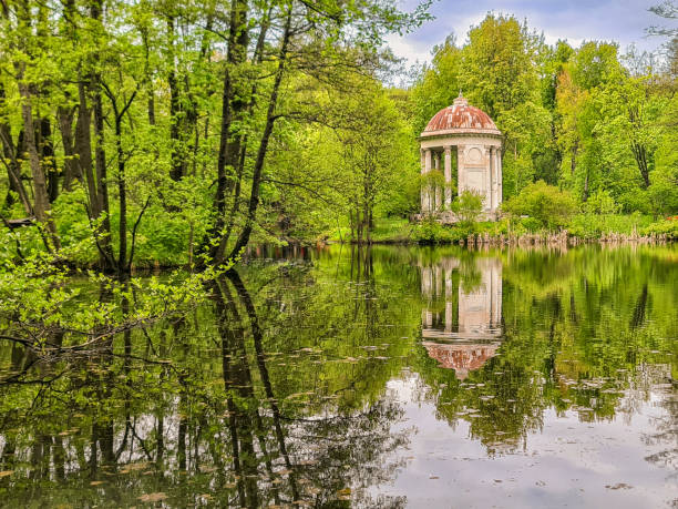 istock Small lake in autumn forest, reflection on water, under blue sky 2159994265