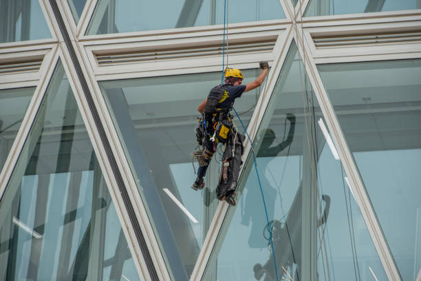 Milan Italy 29 June 2024: A rope operator with a harness, lowering himself onto the facade of a building