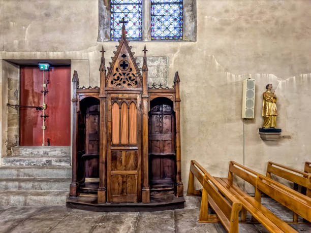 istock Ancient stone church interior with wooden Confession Booth 2159998089