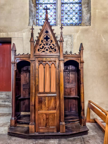 istock Ancient stone church interior with wooden Confession Booth 2159998091