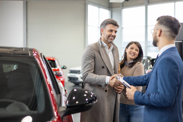 istock Car salesman shaking hand with customer 2160002168
