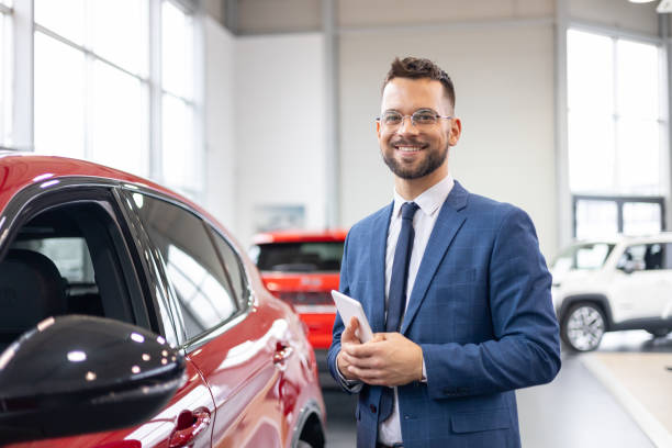 istock Professional man with tablet standing by car 2160002192