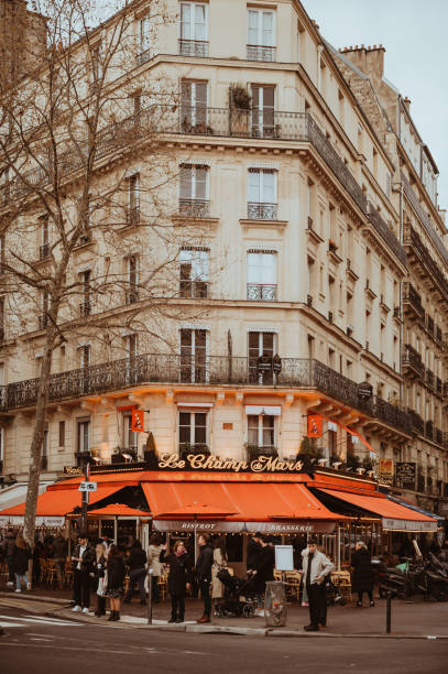 Cozy Parisian sidewalk cafe showcasing elegant tables and chairs with a bustling urban backdrop. Perfect depiction of European lifestyle and charm in an iconic setting.