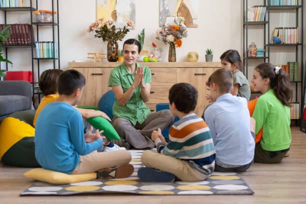 istock Expert teaching sign language to focused children 2160002743