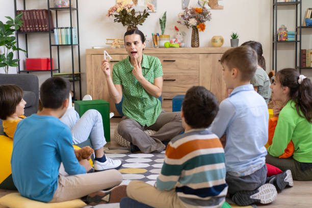 istock Teacher demonstrates sign language to students 2160002745