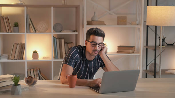 istock Boring work tired man laptop desk cup home office 2160003378
