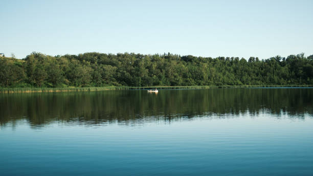 Canoe floating on lake at dusk