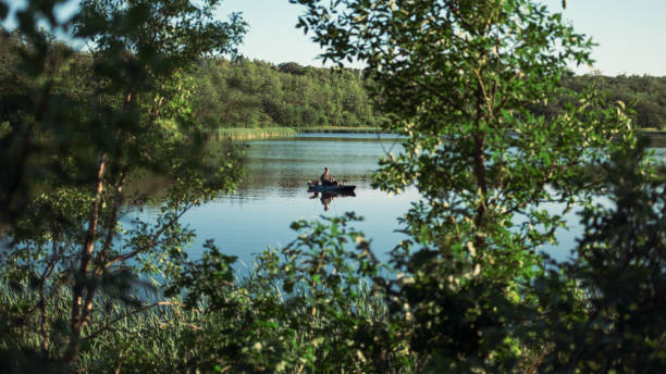 Fisherman in Kayak on lake at dusk