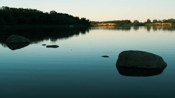 istock Isolated stone in the middle of a lake 2160005049
