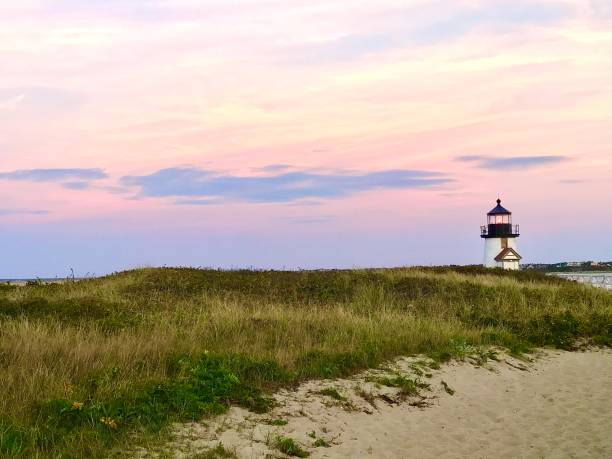 istock Lighthouse by the dunes at sunset 2160005738