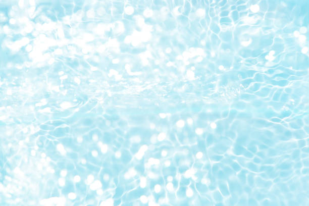 istock Blue water with ripples on the surface. Defocus blurred transparent blue colored clear calm water surface texture with splashes and bubbles. Water waves with shining pattern texture background. 2160006894