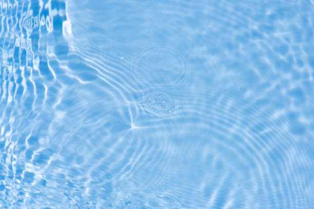 istock Blue water with ripples on the surface. Defocus blurred transparent blue colored clear calm water surface texture with splashes and bubbles. Water waves with shining pattern texture background. 2160006910