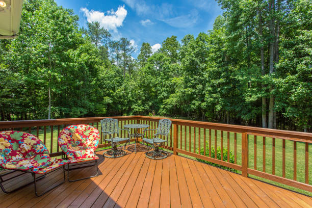 istock Spacious Wooden Deck With Vibrant Seating Overlooking Lush Green Forest 2160007200