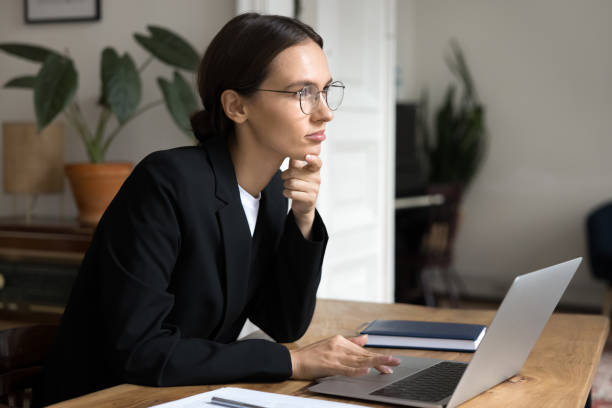 istock Thoughtful dreamy young freelance professional woman thinking on project 2160008968