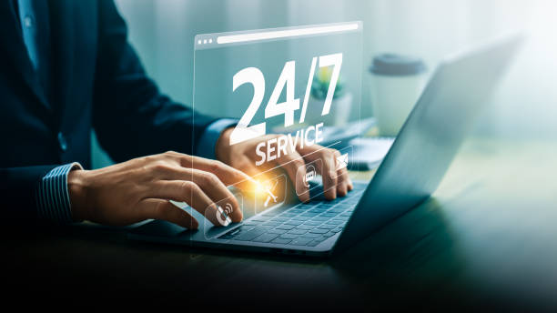 istock Businessman Providing 24/7 Online Support Service Through Laptop with Digital Interface Hologram Displaying Various Customer Assistance Icons, Representing Constant Availability 2160010023