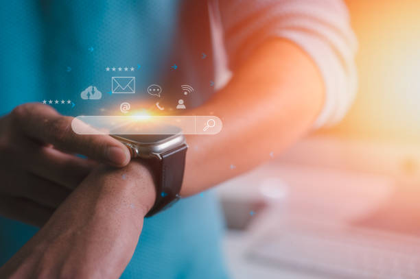 istock a man using a generic smartwatch with a mobile phone on line for searching talking check emails calling or data analysis and social media lifestyle 2160011448