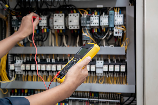 Electrical Power Systems Testing Engineer Testing Electrical System Using A Multimeter To Measure The ...