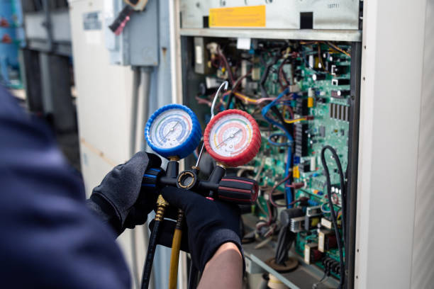 istock Air conditioning, HVAC service technician using gauges to check refrigerant and add refrigerant,Air Conditioning Repair, repairman on the floor fixing air conditioning system. 2160012040