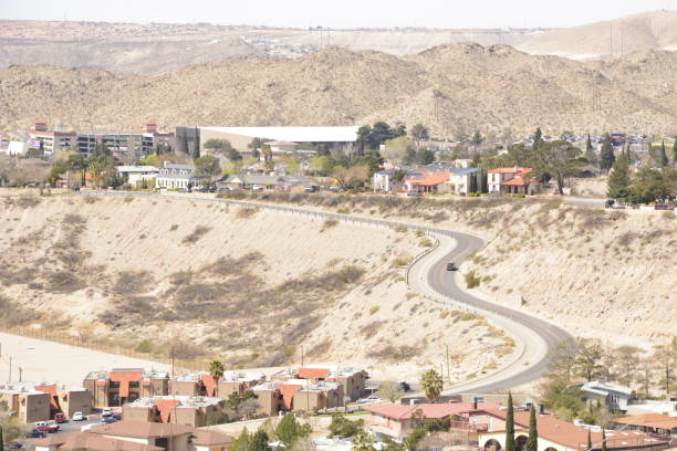 istock Winding City Street Going Up Hill Through Desert 2160014407