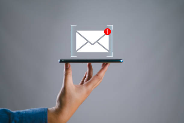 istock hand holding the smartphone shows the icon for new email, send an information message email. smart SMS mail on digital. business communication contact newsletter concept. marketing social media. 2160015125