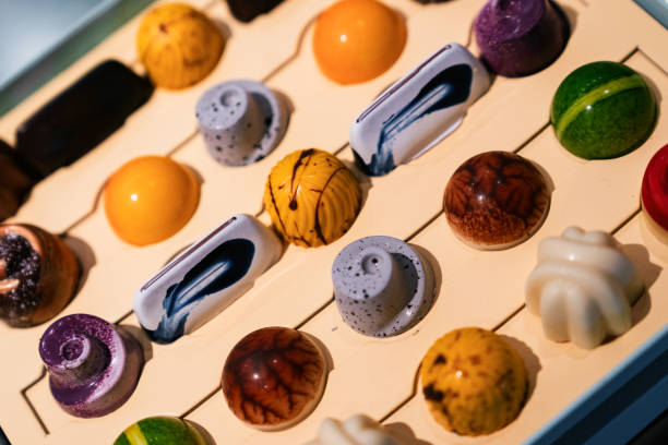 Handcrafted chocolate bonbons in packaging box.
