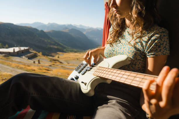 istock Woman with guitar in camper van in mountains 2160018511