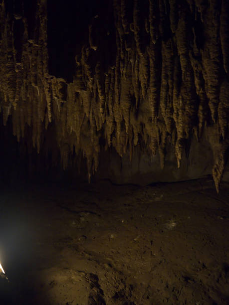 istock Dark cave with stalactites and stalagmites 2160021577