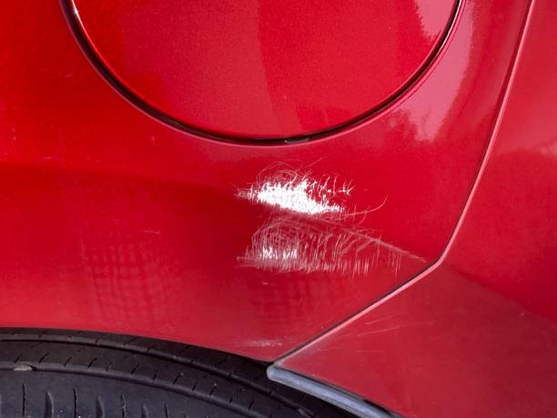 istock Scratch at the left side of a red car 2160022593