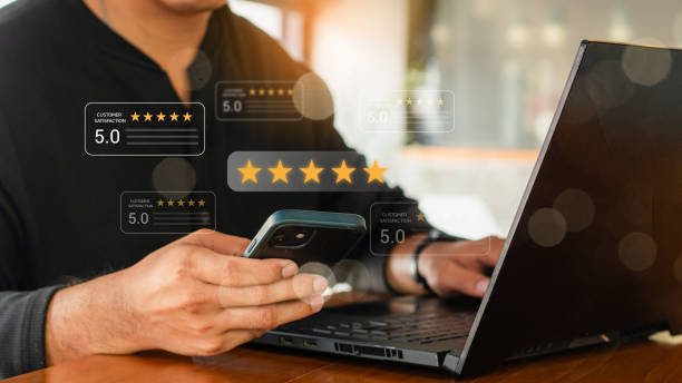 istock close up Man hand using smartphone with popup five star icon for feedback review satisfaction service, Customer service experience and business satisfaction survey. satisfaction survey concept. 2160023115