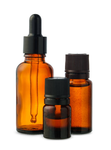 istock Three Amber Glass Bottles With Dropper Tops on White Background 2160024978