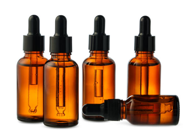 istock Amber Glass Dropper Bottles With Liquid Against a White Background 2160025302