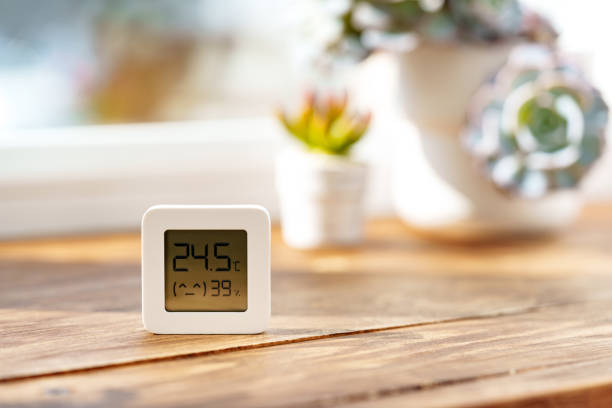 istock Digital Thermometer Displaying Temperature and Humidity Near Window 2160025839