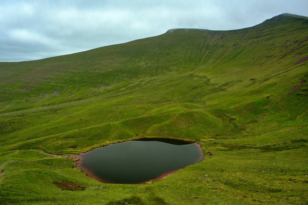 istock Llyn Cwm Llwch lake and two peaks 2160026626