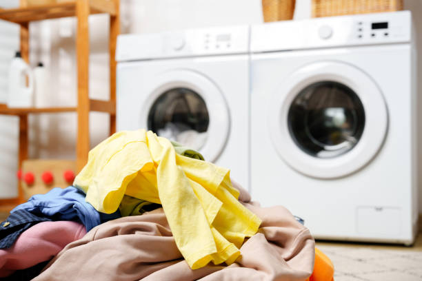 istock Laundry Day in a Modern Home With White Washers and a Wooden Shelf 2160026632