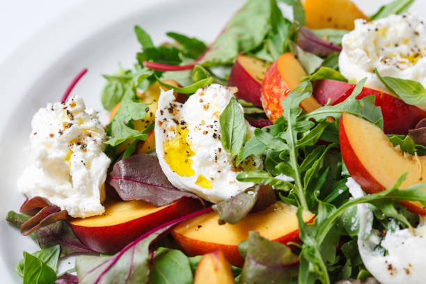 istock Burrata and peaches summer salad, white background. 2160026717