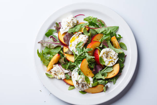 istock Burrata and peaches summer salad, white background. 2160026768