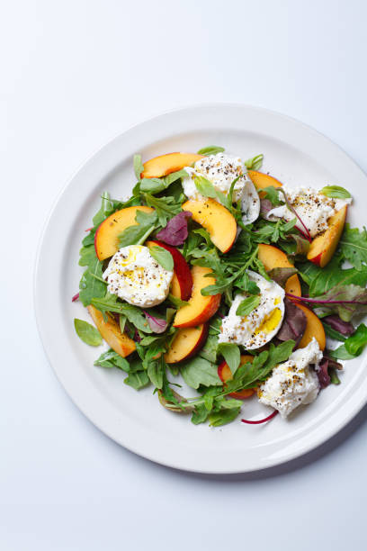 istock Burrata and peaches summer salad, white background. 2160026791