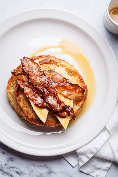 istock French toast with bacon, banana and maple syrup. 2160027534