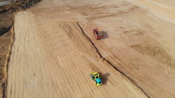 istock Drone view of bulldozers, excavators, and dump trucks showcasing modern construction technology. Use of machines accelerates and optimizes construction processes, enhancing construction quality. 2160028332