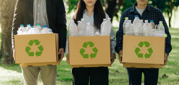 istock CSR corporate social responsibility. Business teamwork recycles policy for environmental sustainability. Business people holding box garbage for recycling. Earth Day, volunteer, Unity. Zero waste. 2160029281