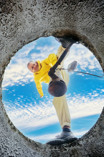 istock Servicing sewer system of private rural home, homeowner submerging sewer pump into sewage. 2160029746