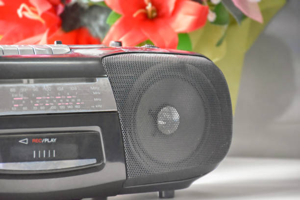Cassette and CD player Cassette and CD player in 1990 style on window with natural blurred background. 1990’s vintage life style concept. open cd player stock pictures, royalty-free photos & images
