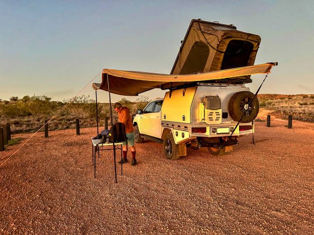 A 4x4 seen through heat haze travelling on an unsealed road in Australia's Northern Territory