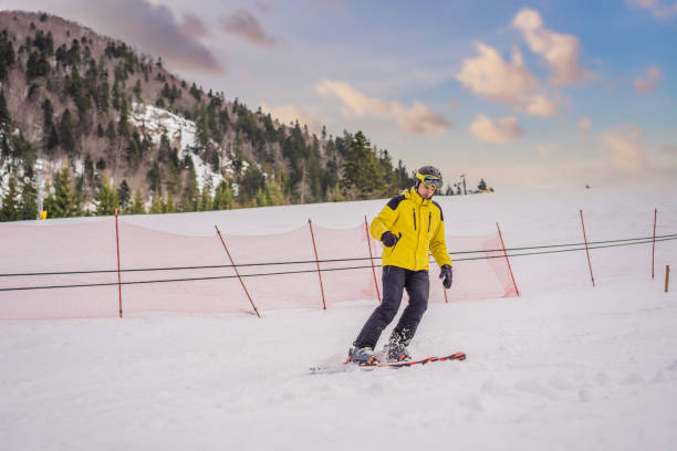istock Ski instructor at training track showing students how to ski 2160032342