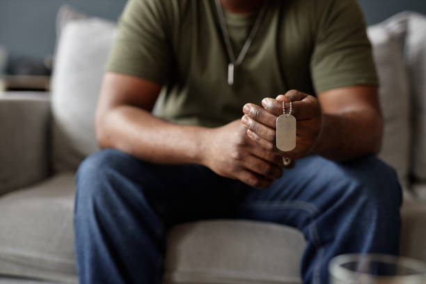 African American Man Holding ID Necklace