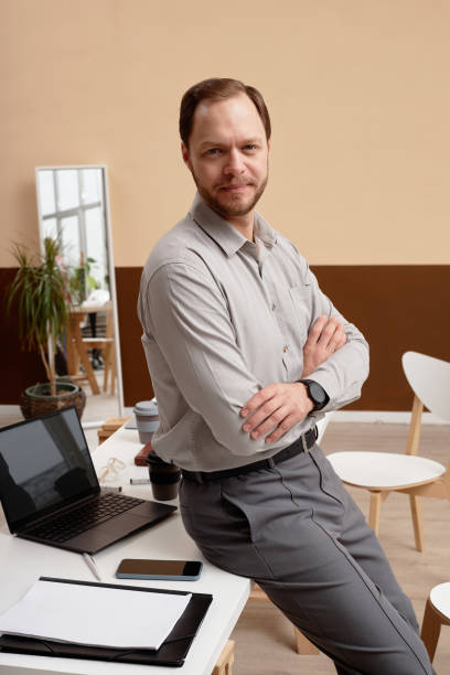 istock Successful Businessman Leaning on Desk in Office 2160033745