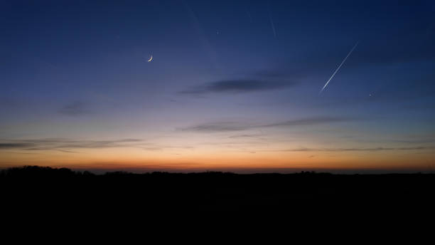istock Moon, shooting star, planets, stars and landscape silhouettes. 2160037574