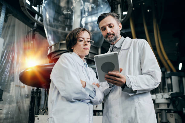 istock Engineers discussing data on the tablet, working at the factory warehouse 2160037780