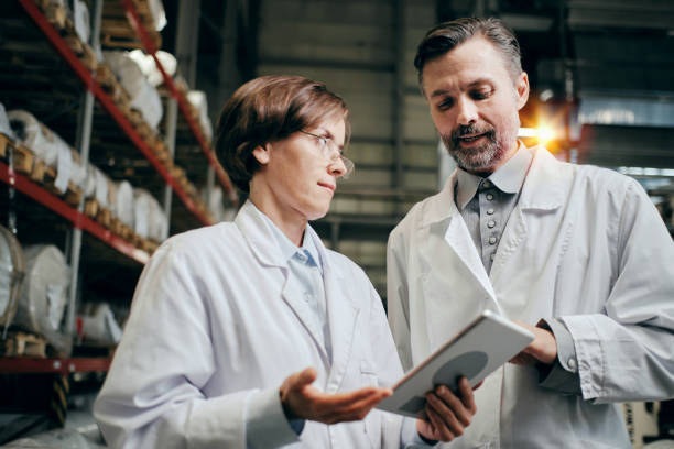 istock Executive and a worker having discussion at the factory warehouse 2160037781